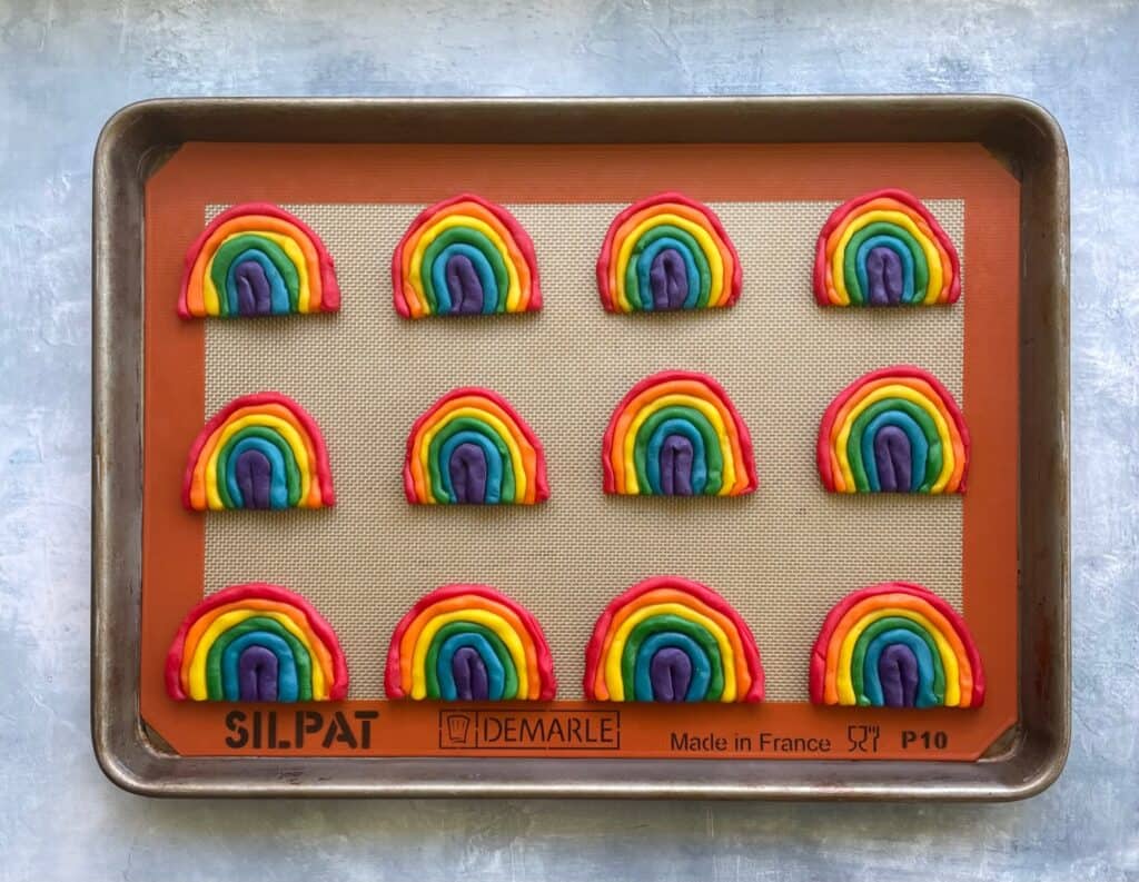 a tray of unbaked rainbow colored cookies.