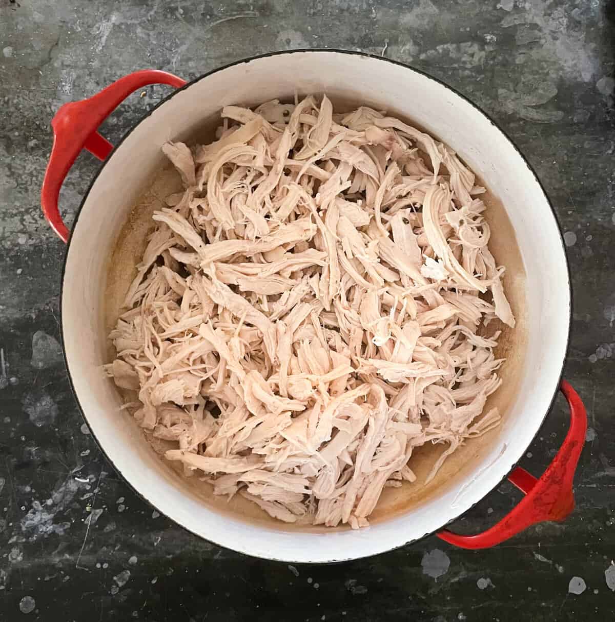 pulled chicken in a Dutch oven.