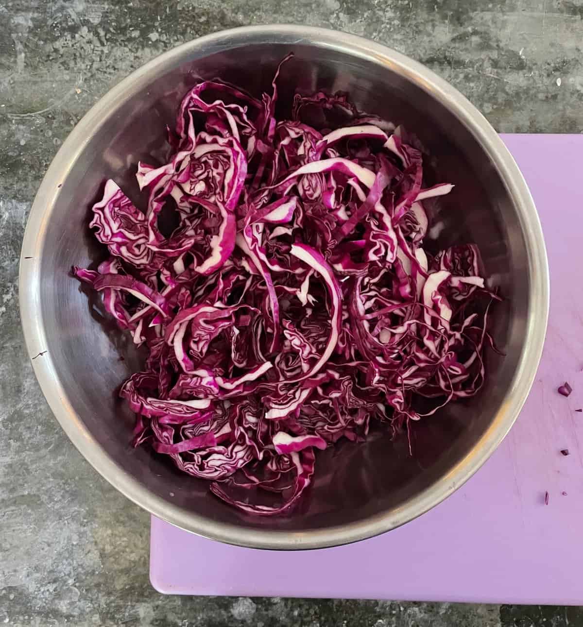 shredded cabbage in a metal bowl.