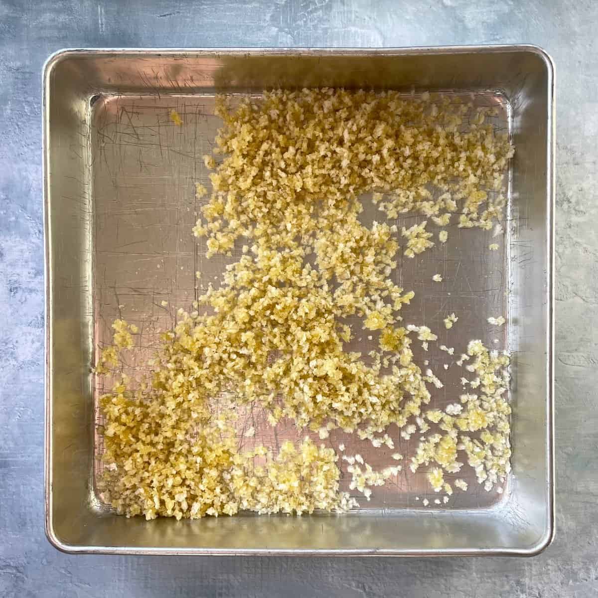 baking pan with panko  mixed with oil.