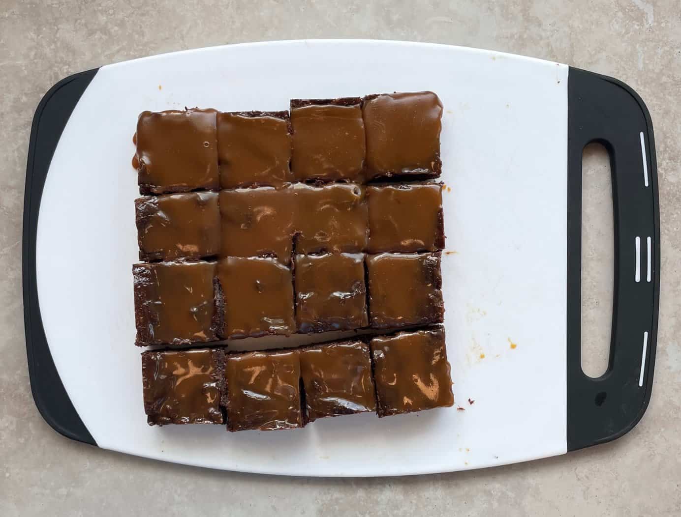 a batch of salted caramel espresso brownies cut into 16 squares.
