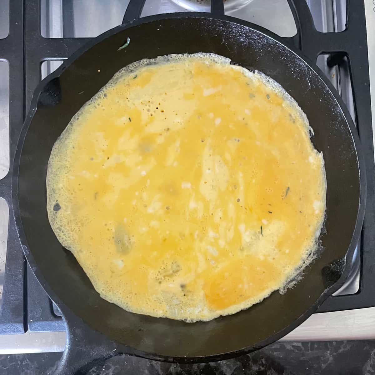 Cast iron pan bottom covered in cooked egg.