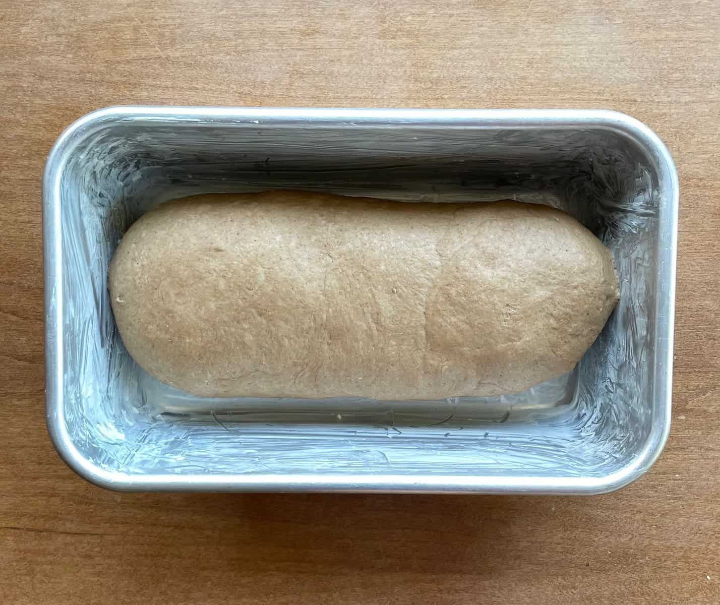 brown bread loaf in a greased loaf pan.