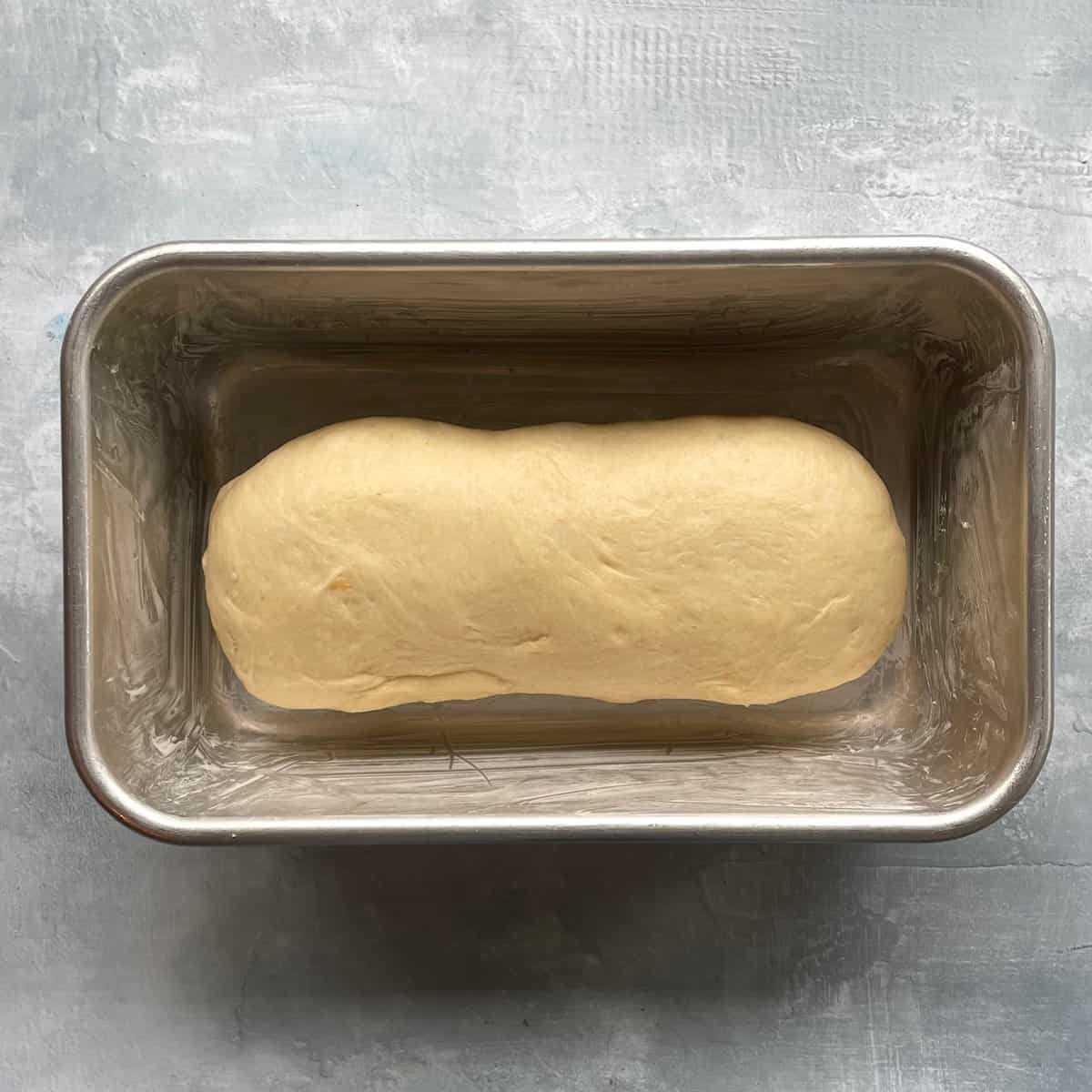 white bread loaf in a loaf pan before rising. 