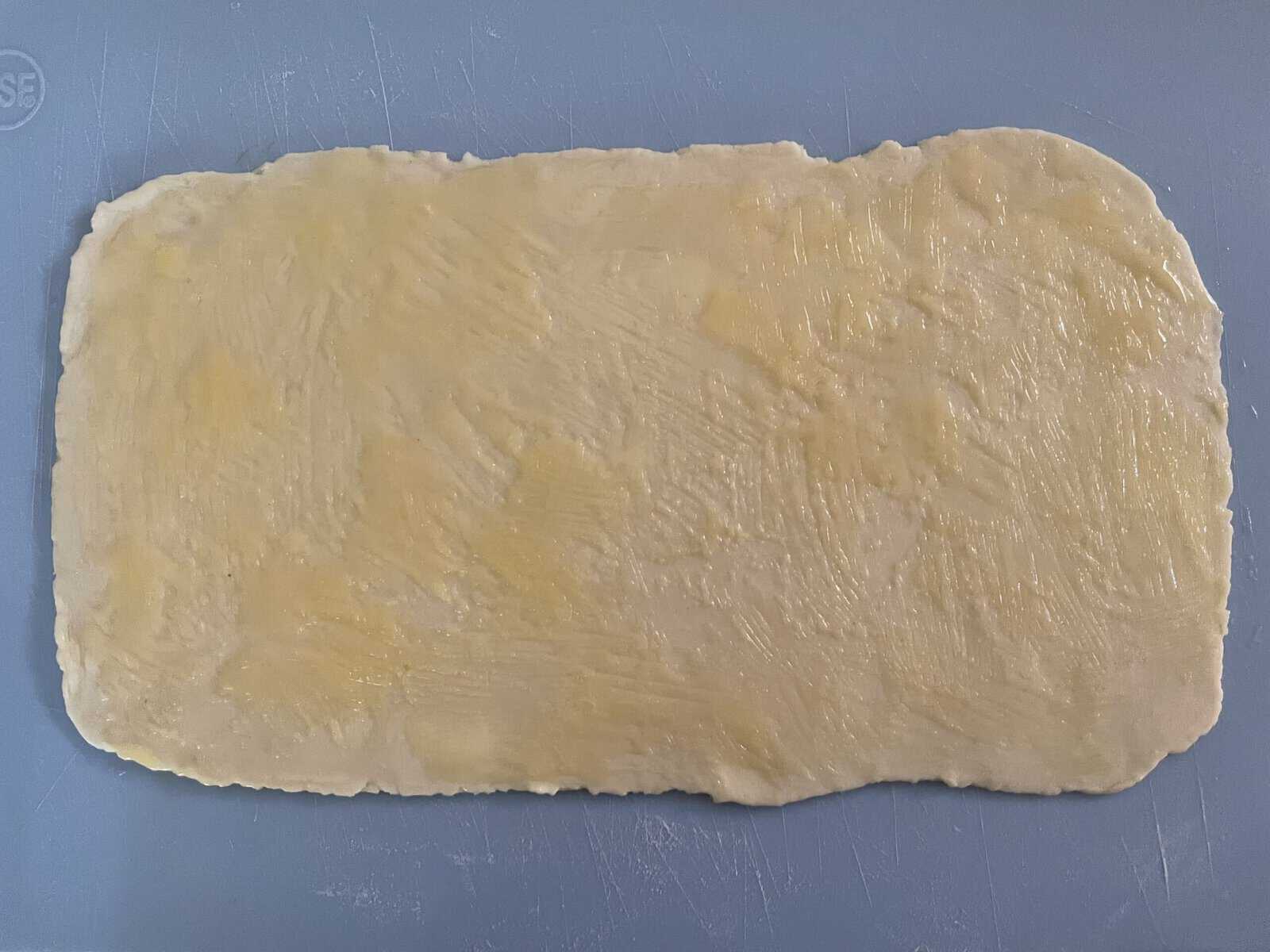 rectangle of rolled out pastry dough brushed with melted butter.