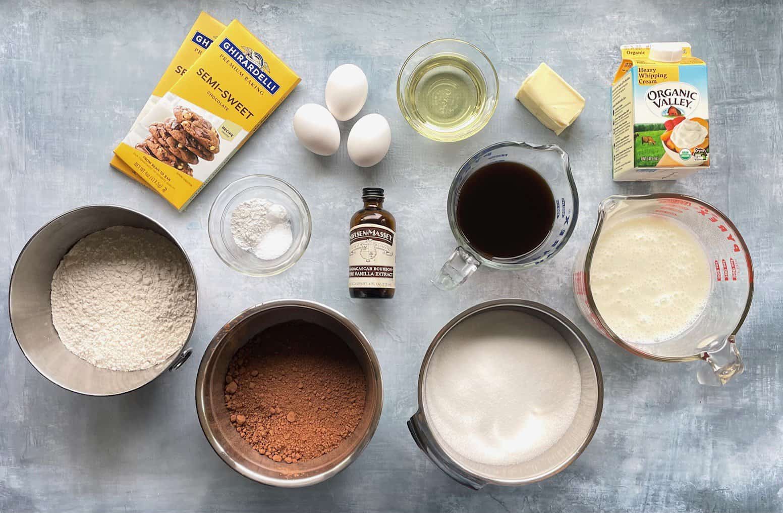 bar chocolate, cocoa, flour, sugar, and other ingredients for a cake and chocolate ganache.