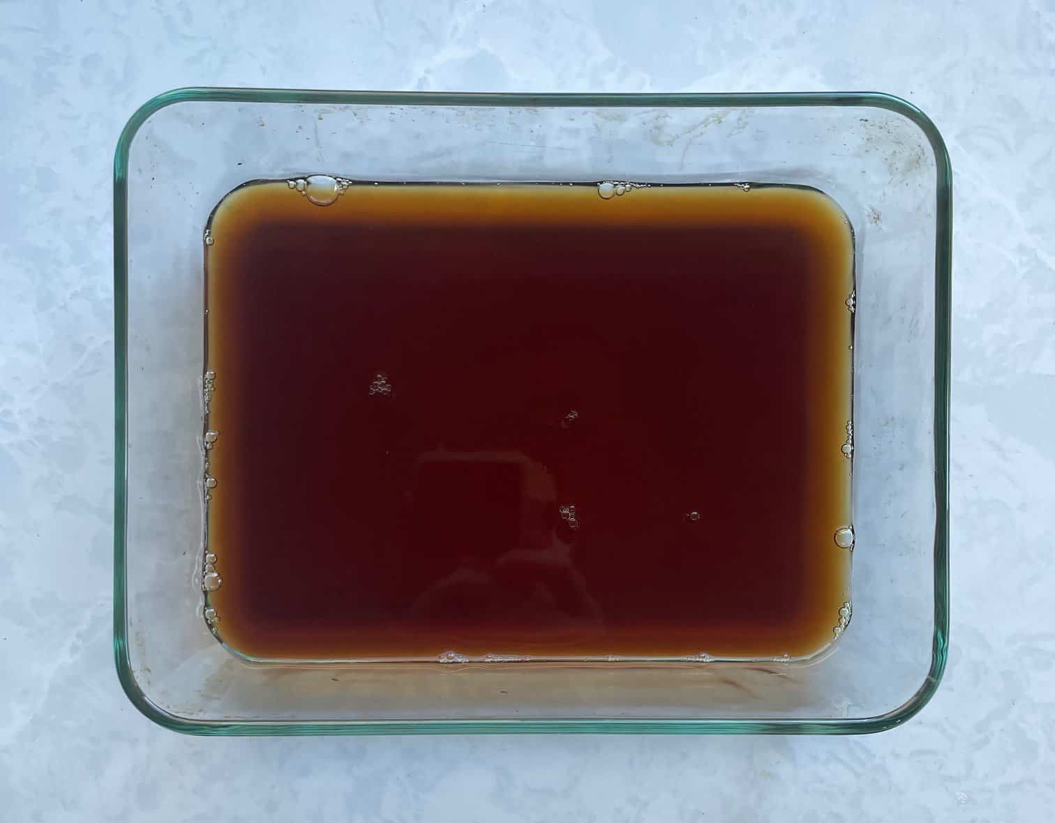 coffee syrup in a flat glass baking pan.