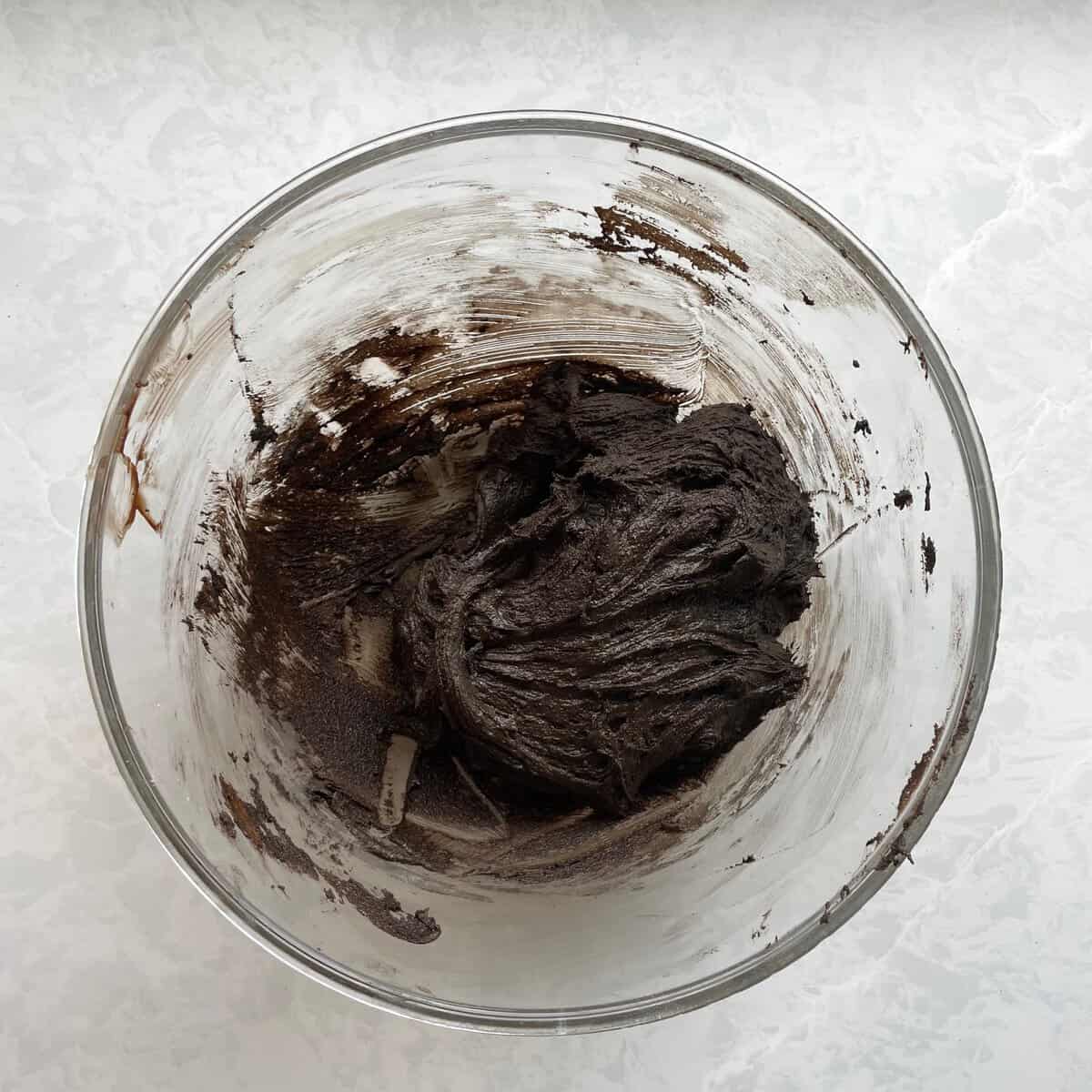 glass bowl with thick dark brownie batter.