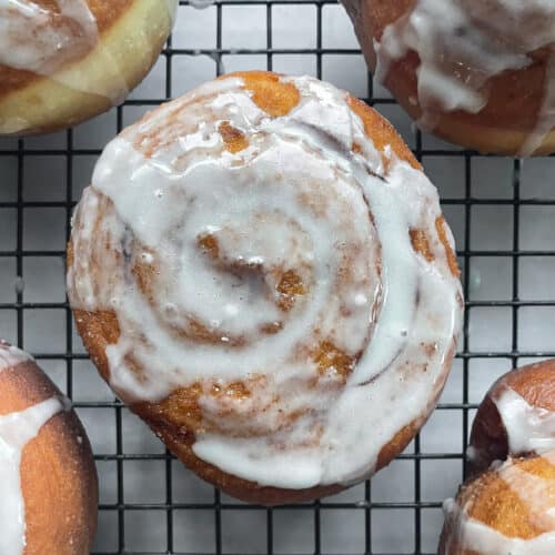 glazed honey bun on a cooling rack.