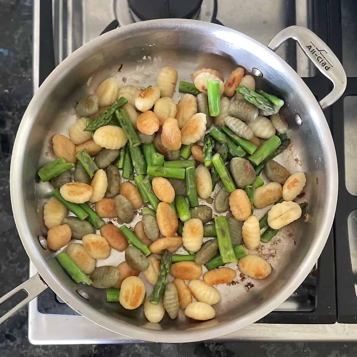 lightly browned gnocchi and chopped asparagus in a large frying pan.
