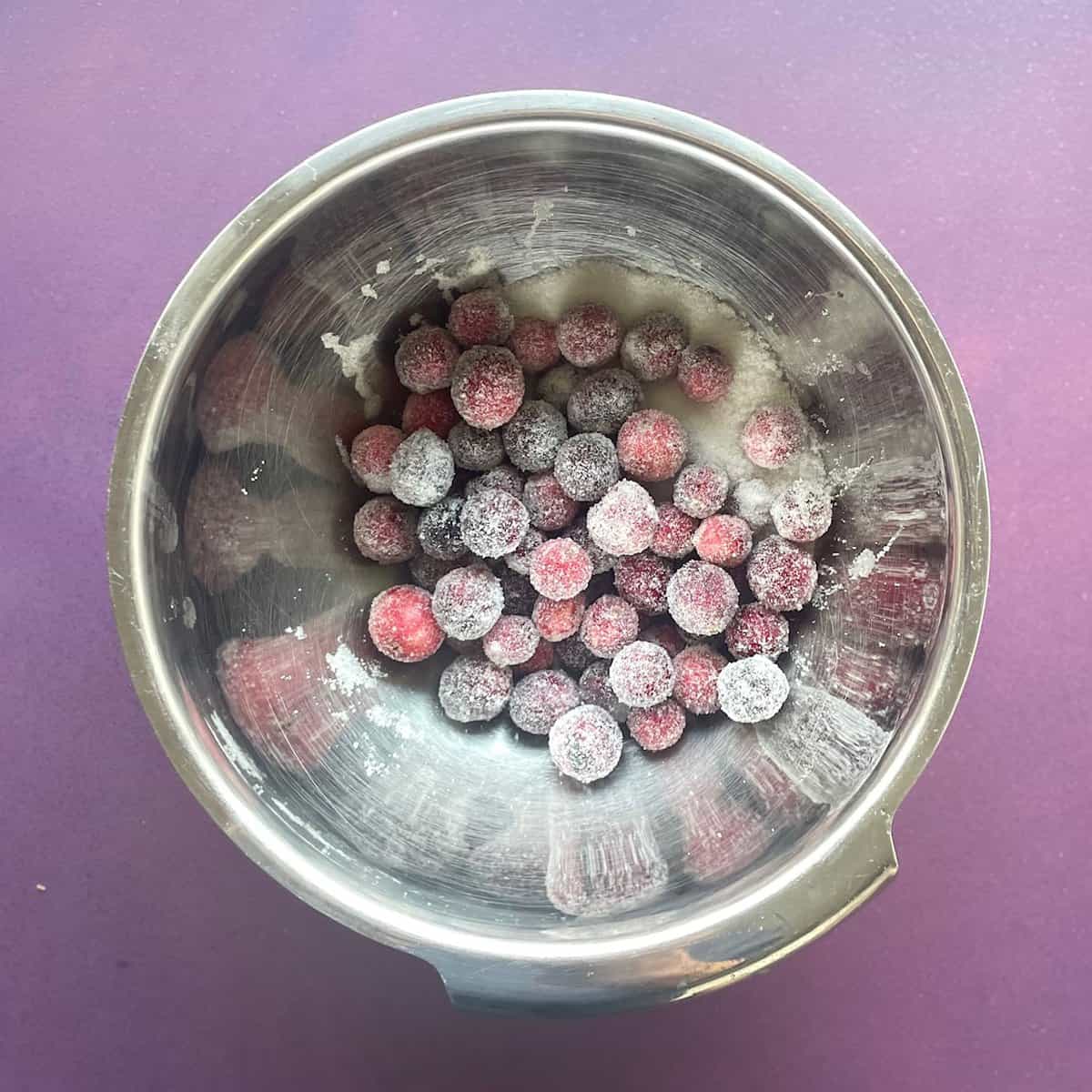 sugared cranberries in a metal bowl.