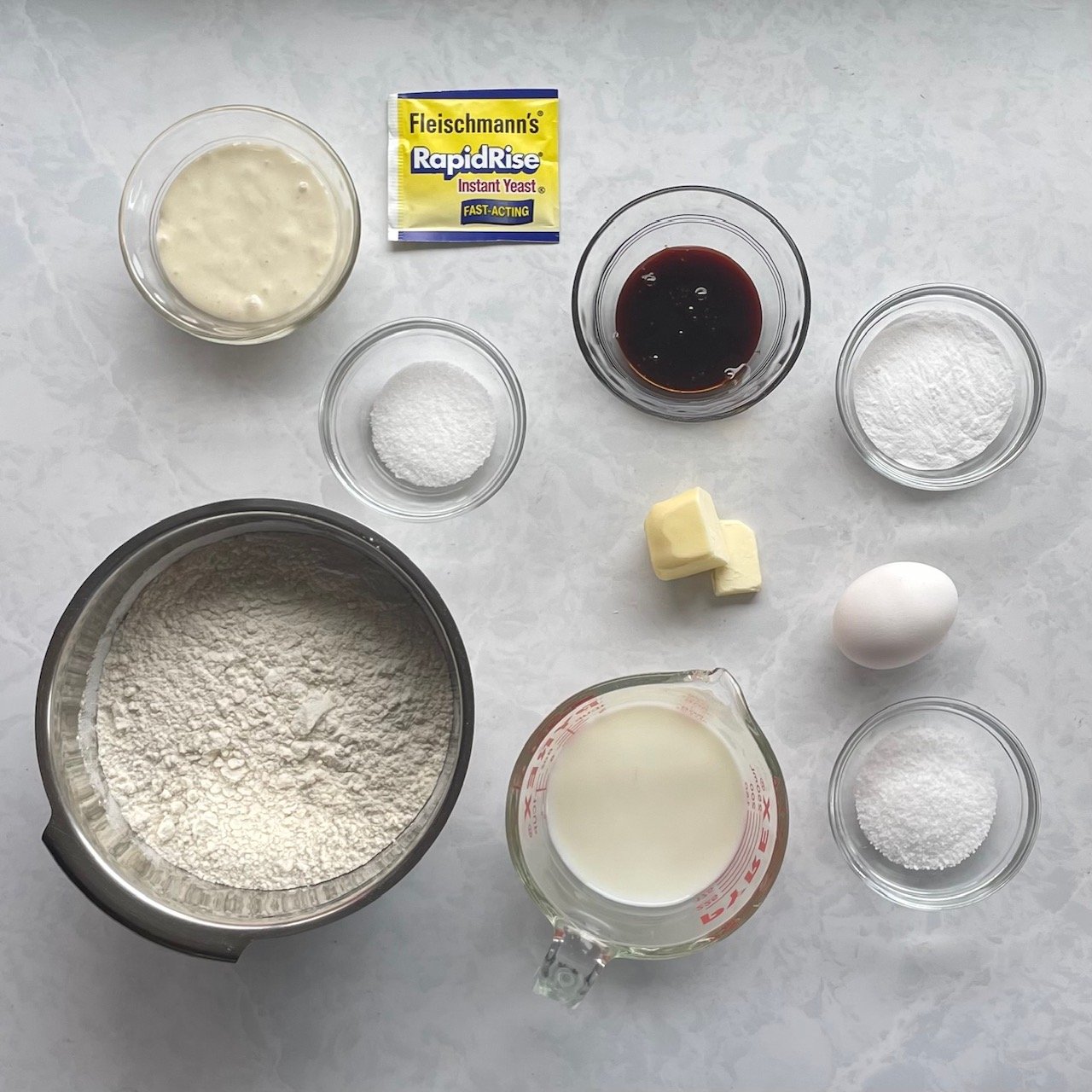 sourdough discard, package of yeast, flour, sugar, milk, butter, malt syrup, egg, and salt.