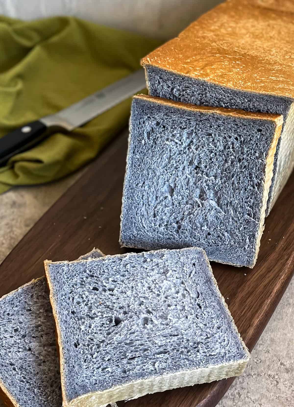 slices of square blue bread on a cutting board.