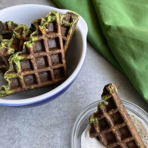 kale waffles and a kale waffle chip dipped into a white dip.