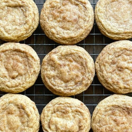 nine snickerdoodle cookies on a baking rack.