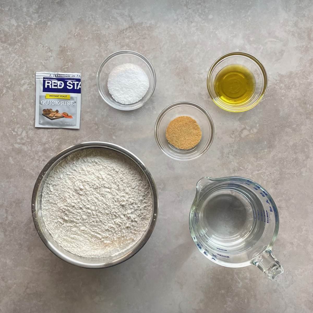 flour, yeast, water, salt, oil, and garlic.
