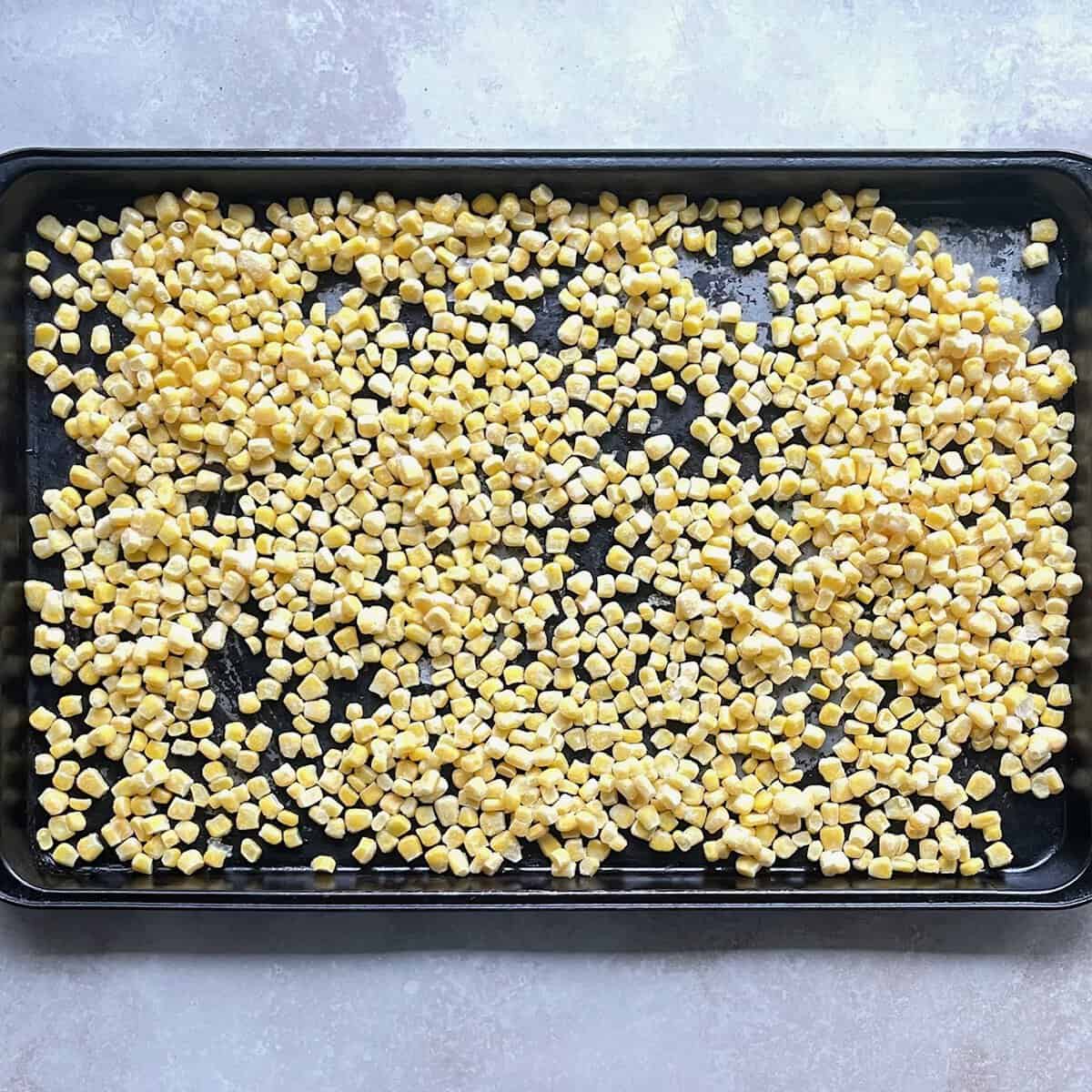 frozen corn kernels on a sheetpan.