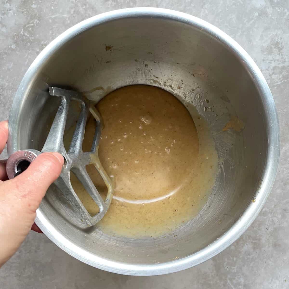 brown liquidy batter in a mixing bowl.