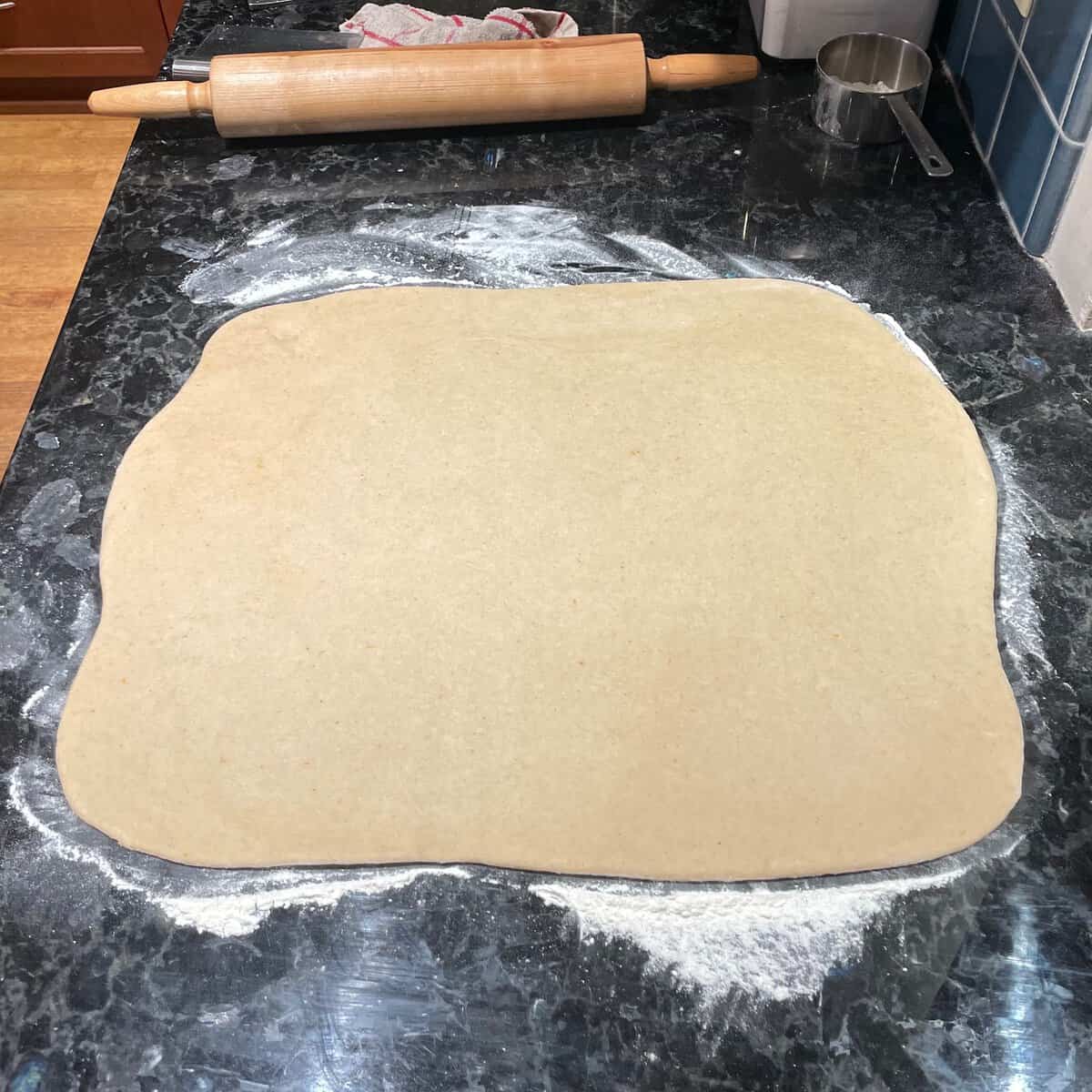 rolled out dough on a floured countertop.