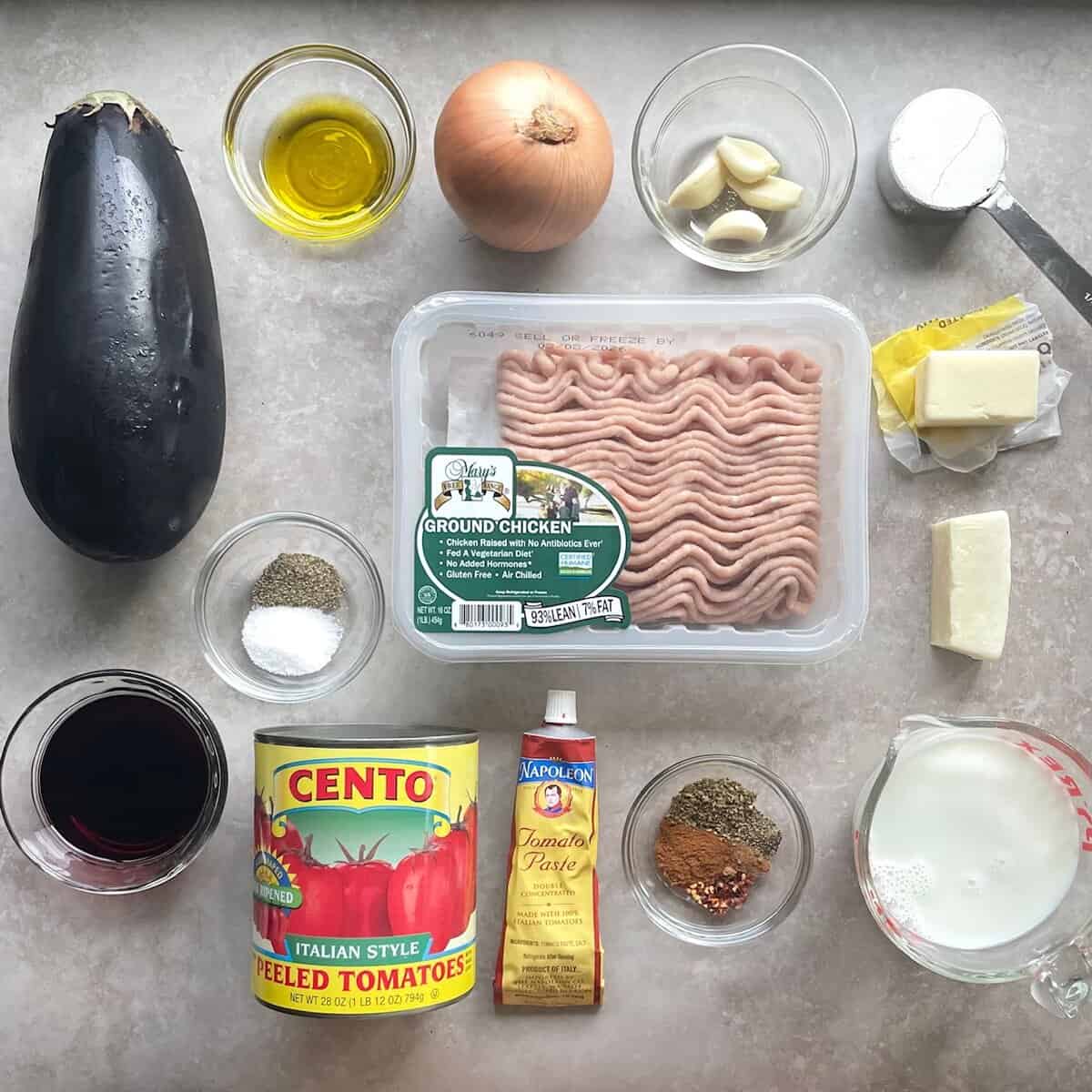 ground chicken, globe eggplant, onion, garlic, olive oil, tomatoes, tomato paste, spices, flour, butter, milk, and chunk of hard cheese.
