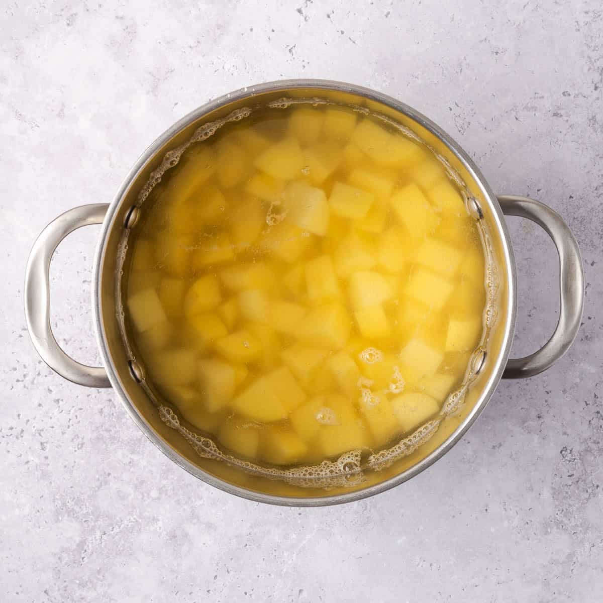 potato cubes in a pot covered with water.