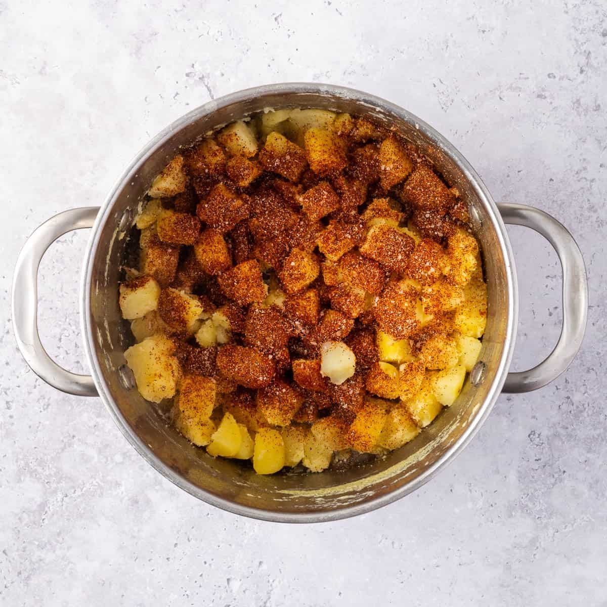 potato cubes in a pot dusted with spices.
