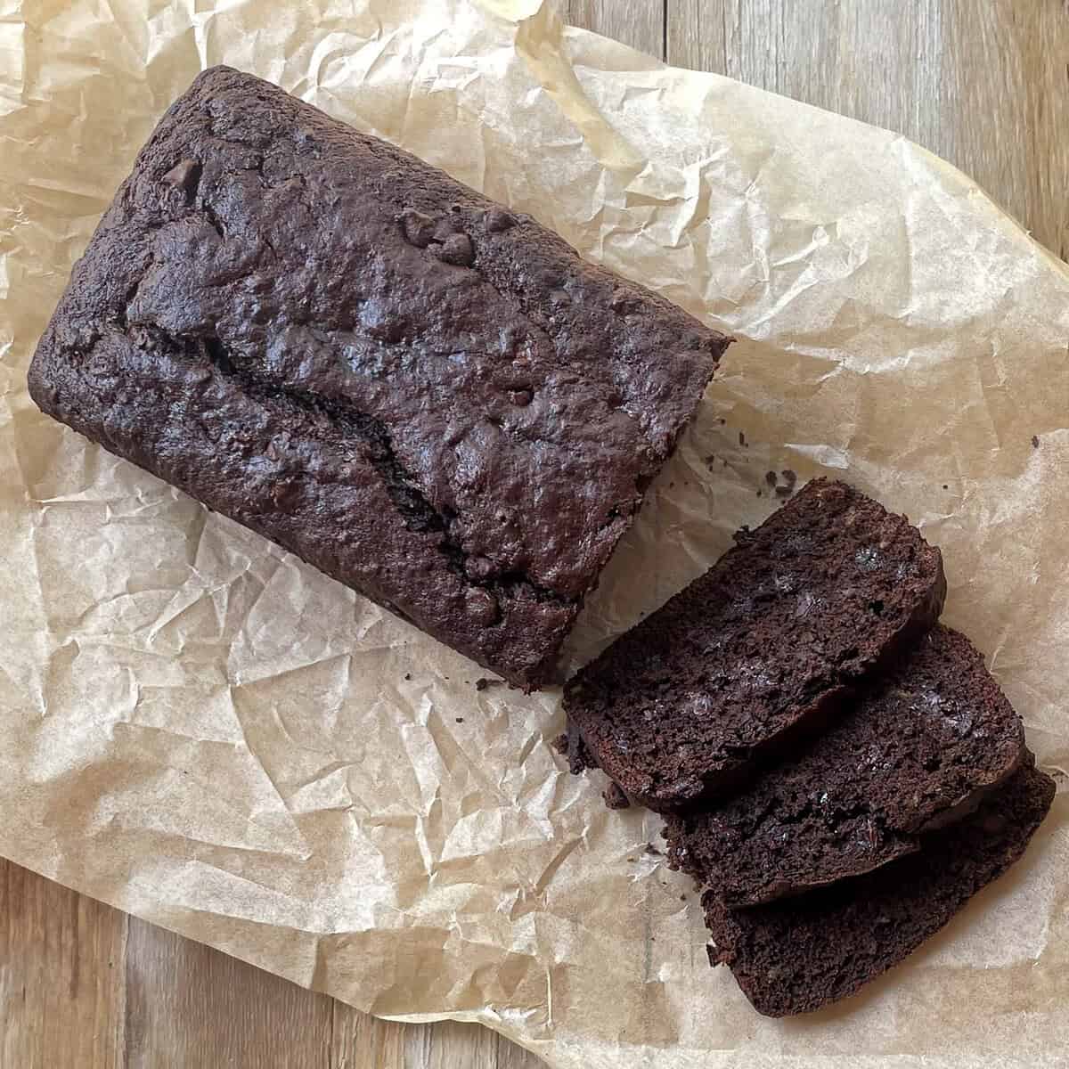 sliced chocolate banana bread on crinkled parchment paper.