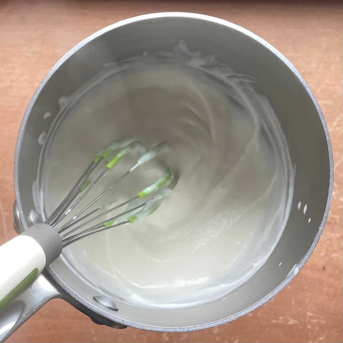tangzhong starter in a pot with a silicone whisk.
