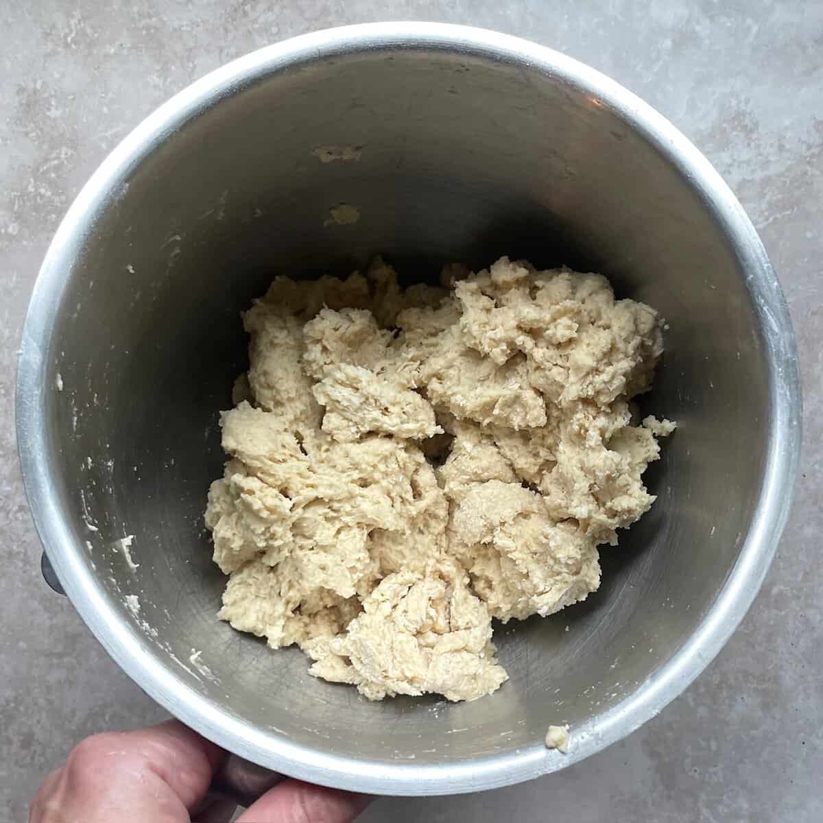 shaggy bread dough in a mixing bowl.