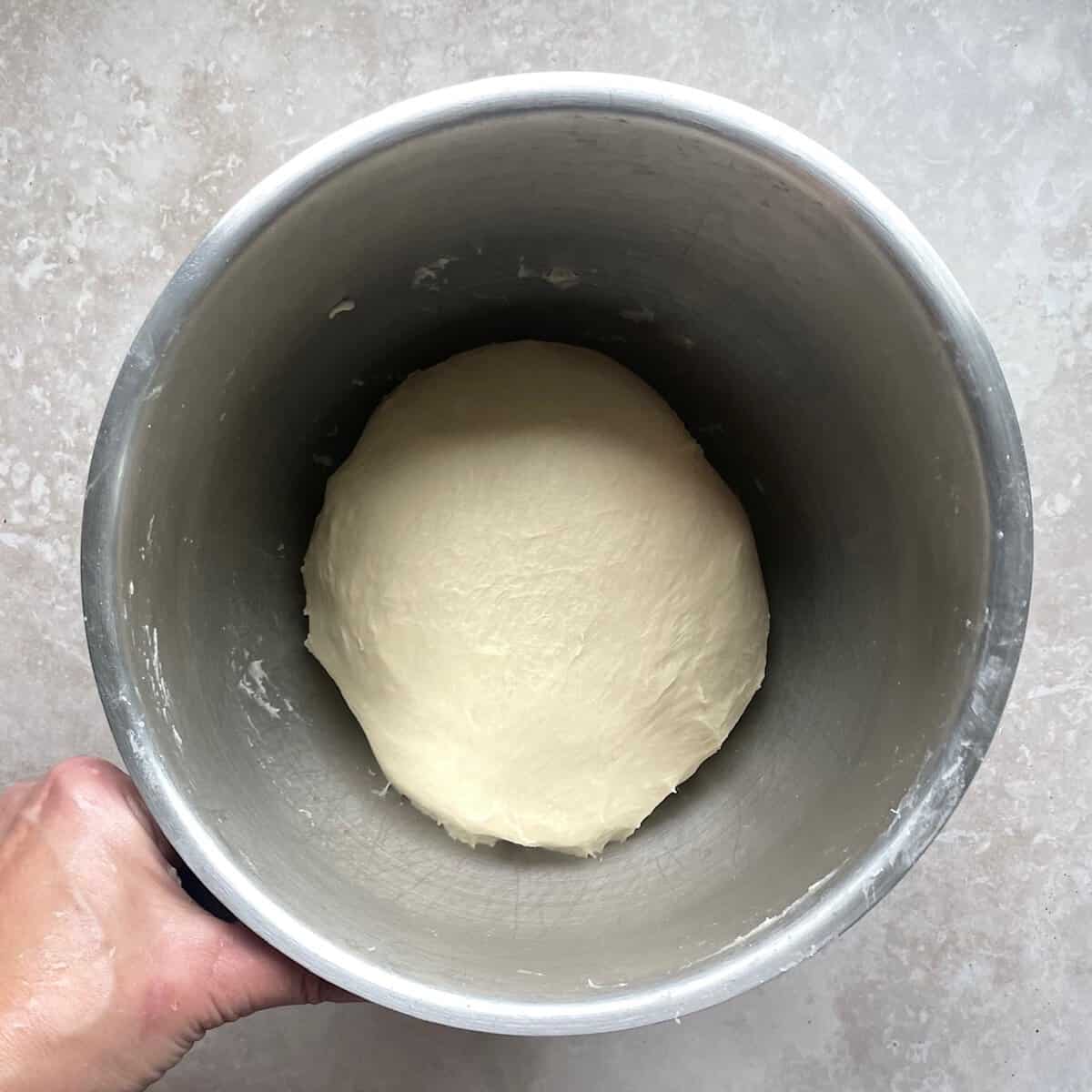 ball of bread dough in a mixing bowl before rising.
