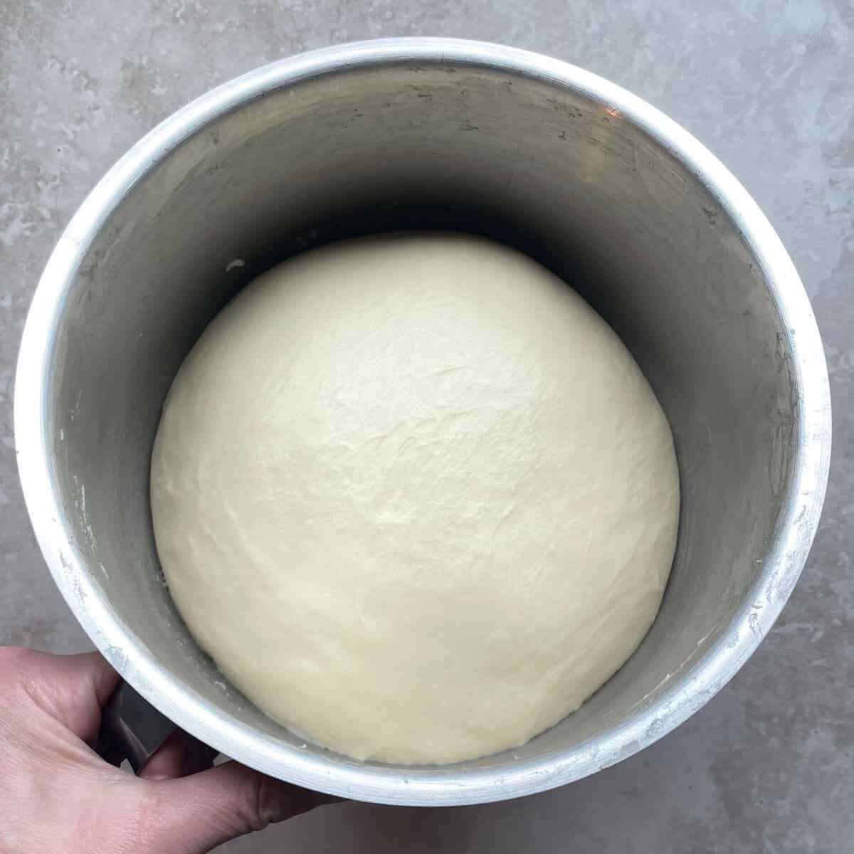puffy ball of bread dough after rising.